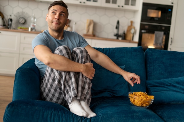 Man with eating disorder trying to eat chips