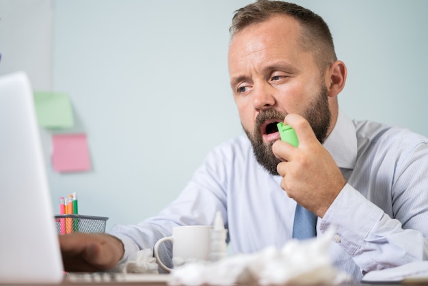 Man with flu working in the office