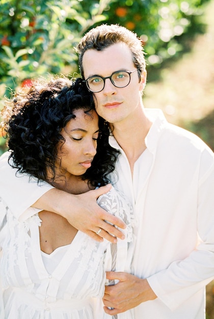 Man with glasses hugs a woman closeup