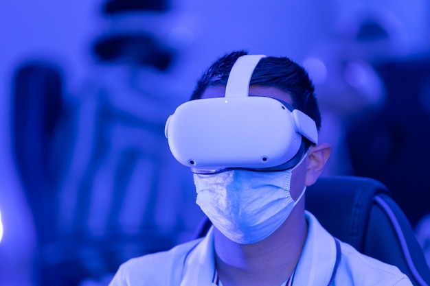 Man with glasses of virtual reality and face mask due to covid pandemic Future technology concept