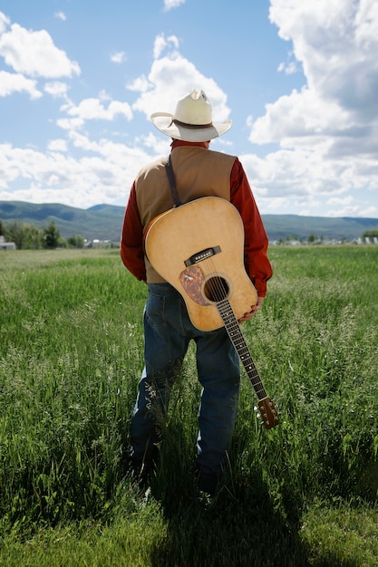 Man with guitar getting ready for country music concert