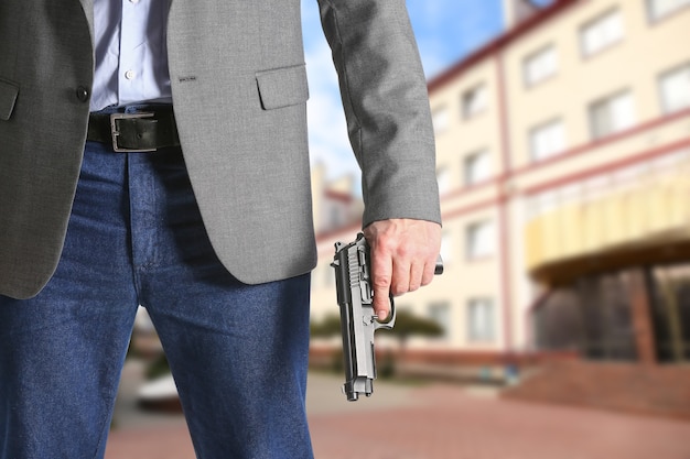 Man with gun near school outdoors