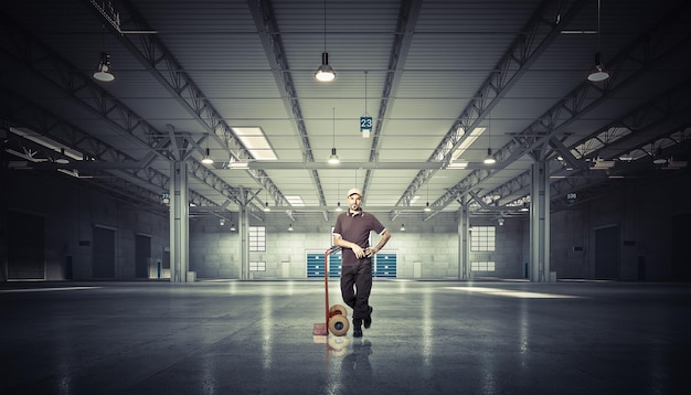 Man with handtruck in warehouse