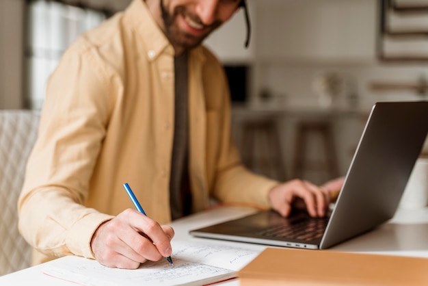 Man with headset having video call on laptop