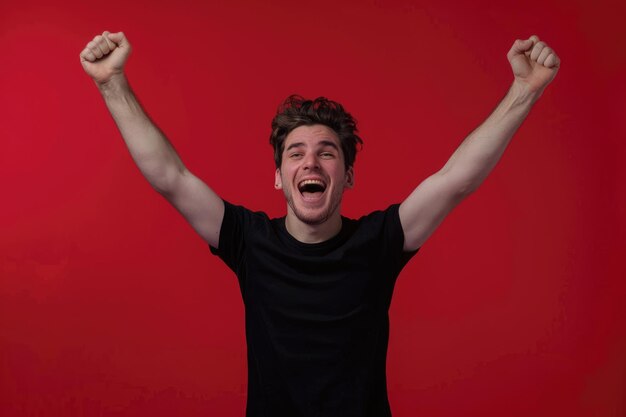 Photo a man with his arms up in the air with a red background