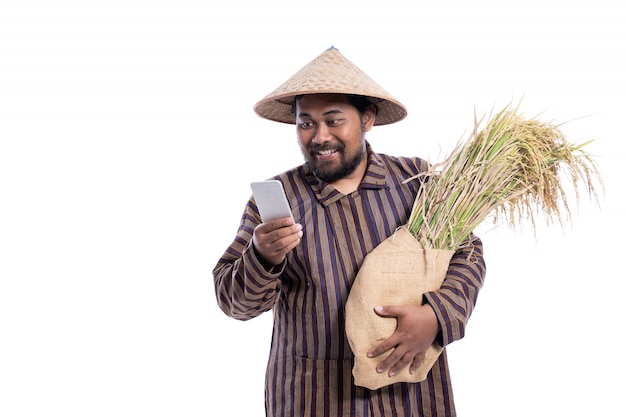 Man with Javanese traditional lurik shirt holding rice grains