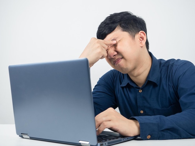 Man with laptop tried from working and feel eyestraincrush eye