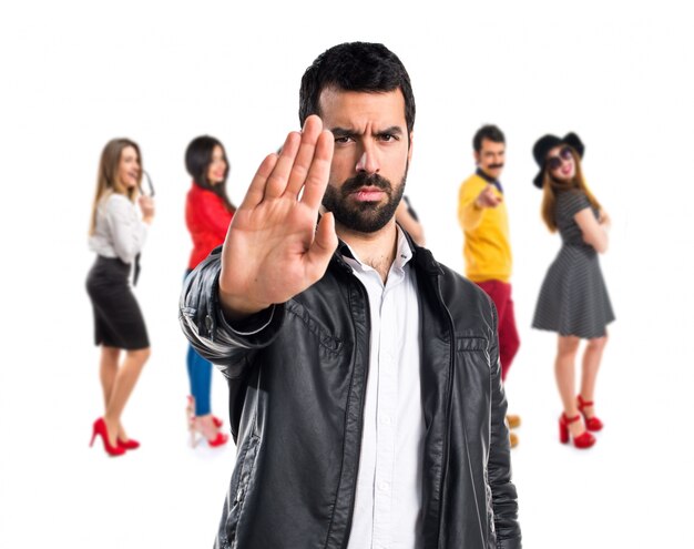 Man with leather jacket making stop sign