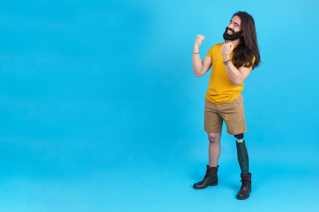 Man with a leg prosthesis celebrating raising the fists