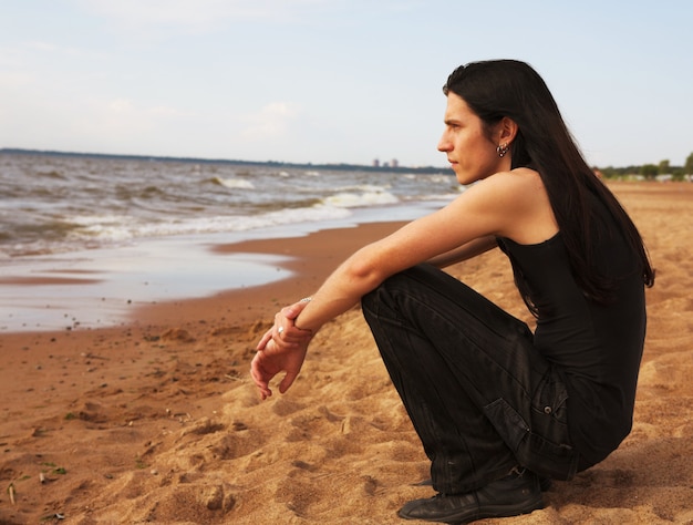 Man with long hair on the beach