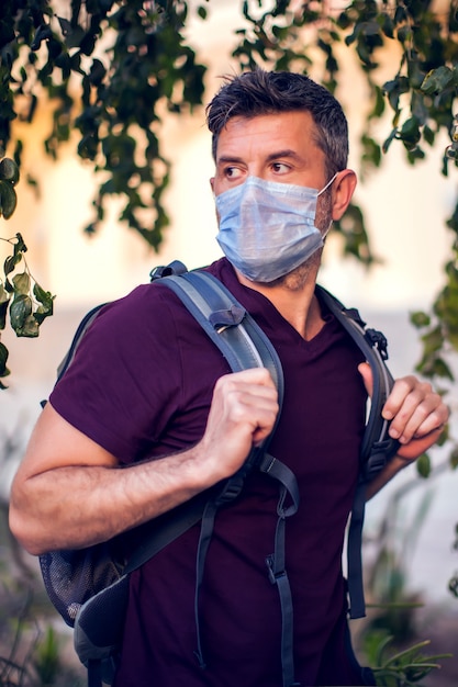 Man with medical mask outdoor. People, healthcare and medicine concept