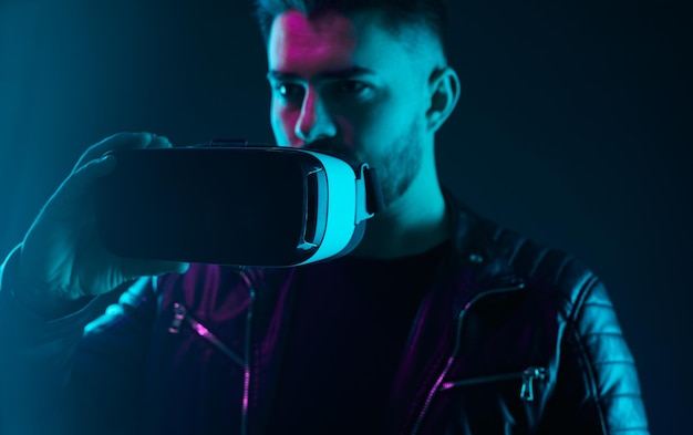 Man with modern vr headset in dark studio