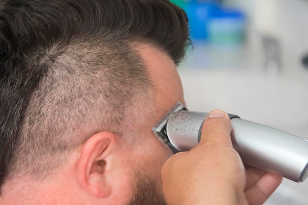 A man with a mohawk and beard in the barbershop