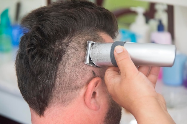 A man with a mohawk and beard in the barbershop