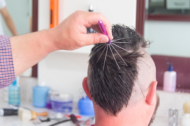 A man with a mohawk and beard in the barbershop