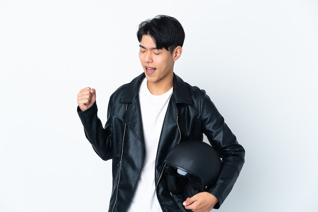 Man with a motorcycle helmet isolated celebrating a victory