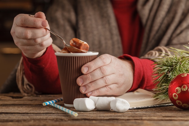 Man with mug hot cocoa with marshmallows, winter Christmas drink