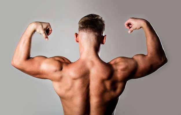 Man with muscular arms, triceps. Waist, waistline. Guy with beautiful torso.