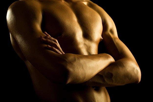 Man with naked torso on black background