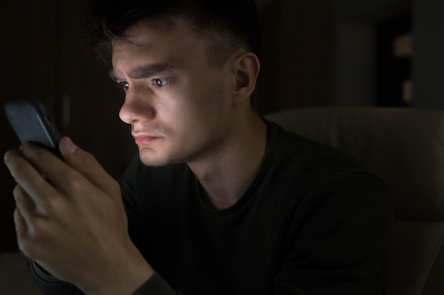 Man with phone in the night. Social media addiction.