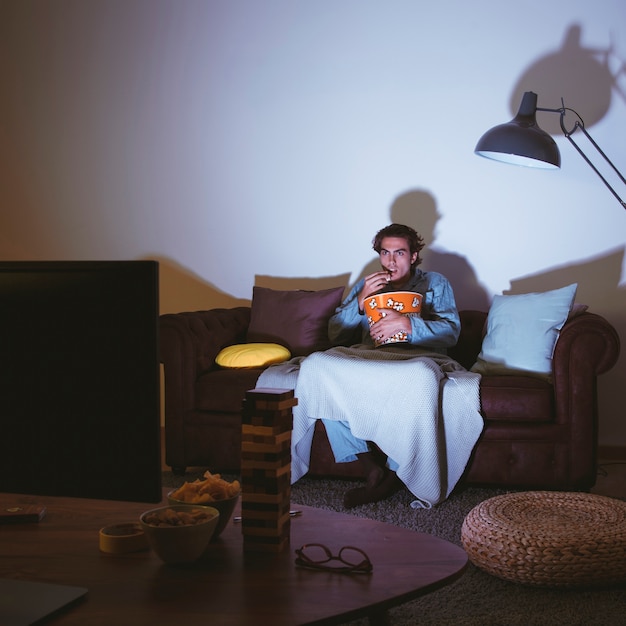 Man with popcorn having a movie night