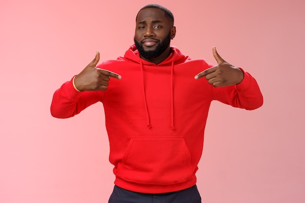 Man with a red sweatshirt over pink