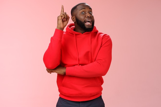 Man with a red sweatshirt over pink