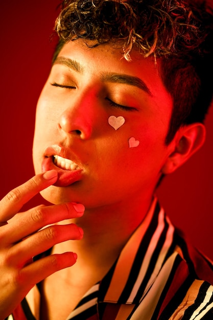 man with rose petals on red background