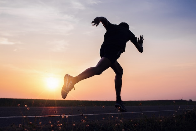 The man with runner on the street be running for exercise.