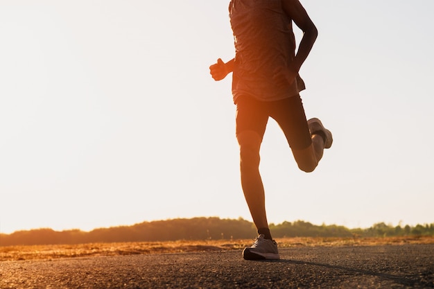 The man with runner on the street be running for exercise.