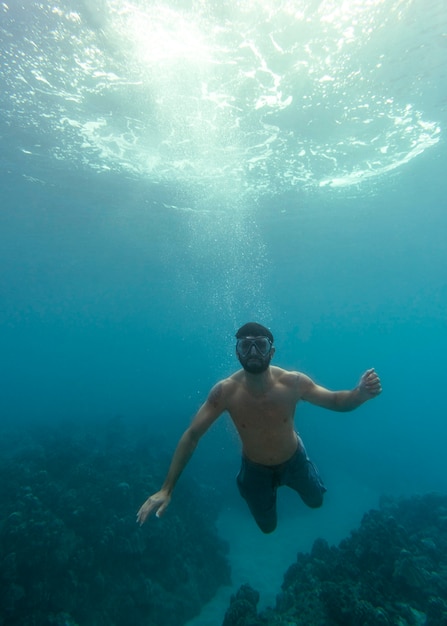 Man with scuba gear swimming in the ocean