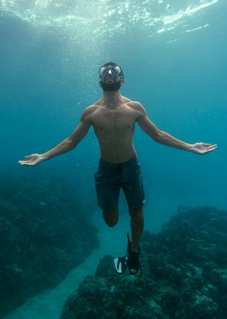 Man with scuba gear swimming in the ocean