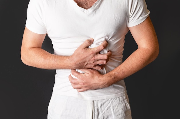 Man with severe stomach ache Gastroenterology Medicine and treatment concept