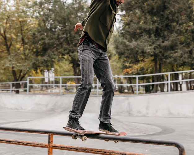 Man with skateboard outside in the city park