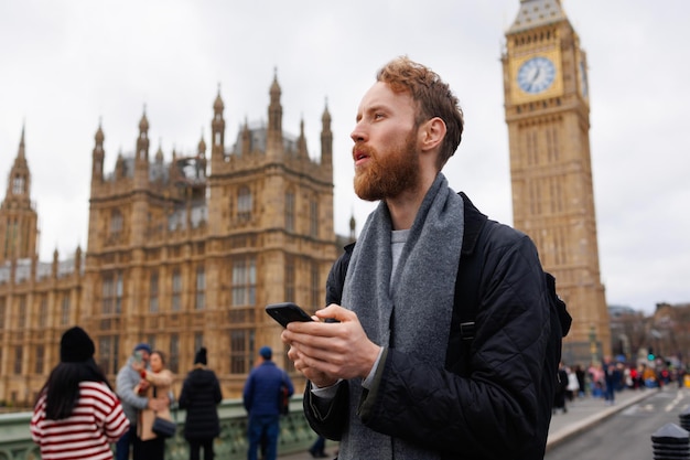 Man with a smartphone in his hands on the streets of London