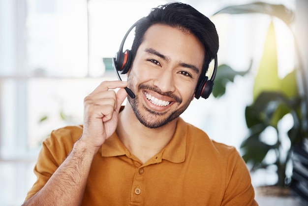 Man with smile in portrait call center employee and contact us with headset and microphone CRM and help desk agent Happy male consultant communication and tech customer service job and telecom