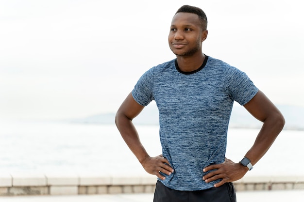 Man with sportive body and in good shape looking away and posing while standing