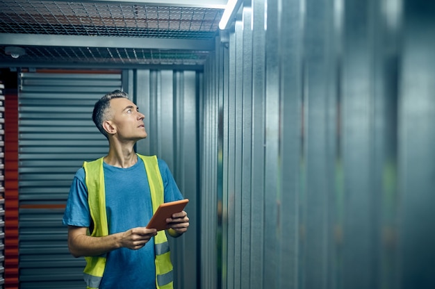 Man with tablet looking up in garage box