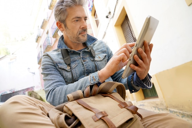 man with a tablet in the street