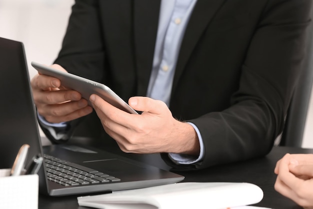 Man with tablet at table in office Consulting service concept