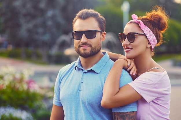 A man with tattoos on his arms and a redheaded woman on a date.