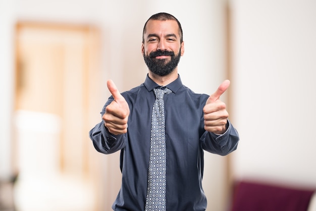 Man with thumb up on unfocused background