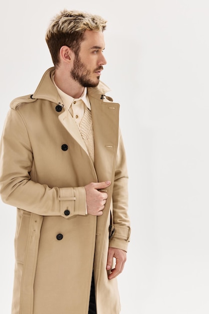 Man with trendy hairstyle in beige coat modern style autumn clothing