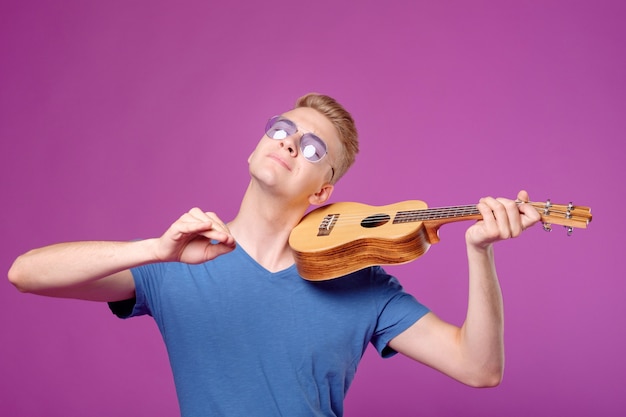 man with ukulele in hands plays like violin