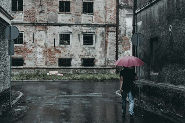 Man with umbrella on rainy day in town