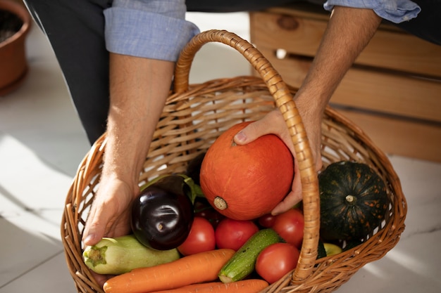 Man with vegetables that have been cultivated and farmed indoors