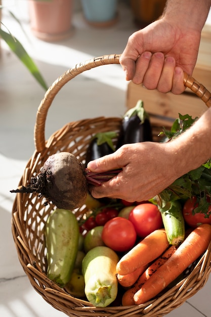 Man with vegetables that have been cultivated and farmed indoors