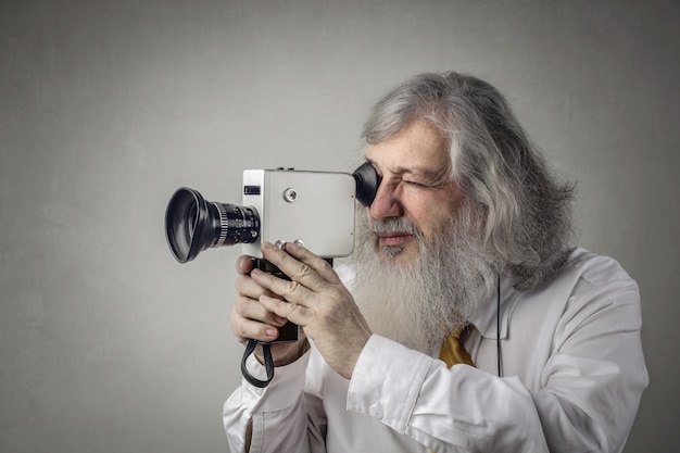 Photo man with vintage video camera 