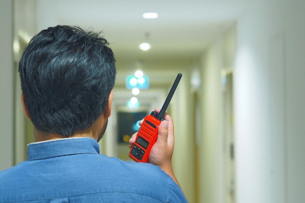 Man with a Walkie Talkie or Portable radio transceiver for communication