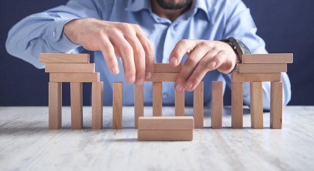 Man with wooden blocks. Business concept